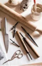  ??  ?? Sheets of clay are sliced using a cutting wire (top). Some of Chrissy’s tools, including scissors to snip the plants out of the clay once pressed; knife, rolling pin; volcanic rocks and coral for marking the seam decorative­ly; letterpres­s tools for stamping her initials (above).