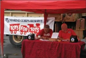  ?? CHARLES PRITCHARD - ONEIDA DAILY DISPATCH ?? Members of the Madison County Marine Corps Toys for Tots set up at the Make’N Bacon Fest at Vets Field in Oneida on Saturday, Oct. 7, 2017.