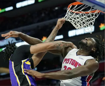  ?? Associated Press ?? Pistons center Isaiah Stewart blocks a dunk attempt by Lakers forward Anthony Davis in the first half Sunday. Davis was denied this time but finished with 30 points in the Lakers’ 121-116 win.