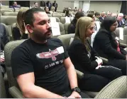  ?? AP PHOTO BY KATHLEEN RONAYNE ?? Shane Fedderman, left, a 1998 graduate of Marjory Stoneman Douglas High School in Parkland, Fla., watches as families of mass shooting victims urge California’s public pension funds to stop investing in retailers of assault weapons in Sacramento, on...