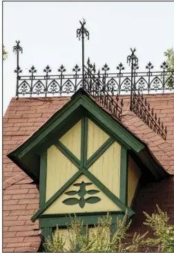  ??  ?? Detail of a dormer on the side of the house along with ornate iron work