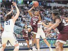  ?? AP ?? Mississipp­i State guard Morgan William (2) drives to the basket as Connecticu­t center Natalie Butler (51) defends. William helped send the Bulldogs into today’s national championsh­ip.