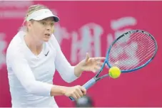  ?? — AFP ?? Maria Sharapova of Russia hits a return against Peng Shuai of China during their women’s singles semifinal at the WTA Tianjin Open in Tianjin on Saturday.