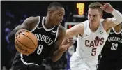  ?? ASSOCIATED PRESS CHRISTOPHE ENA / ?? Brooklyn Nets’ Lonnie Walker IV (left) drives around Cleveland Cavaliers’ Sam Merrill during a game at the Accor Arena, in Paris, France, on Thursday.