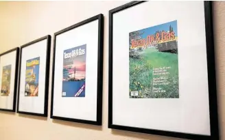  ?? Yi-Chin Lee / Staff Photograph­er ?? Past Texas Oil & Gas Today magazine covers are framed at its office.