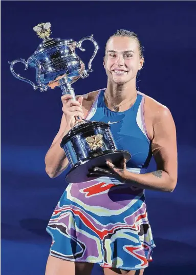  ?? Lintao Zhang/Getty Images ?? Aryna Sabalenka poses with the Daphne Akhurst Memorial Cup after winning the Australian Open title against Elena Rybakina on Saturday in Melbourne.