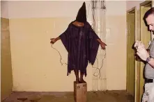  ?? Associated Press file ?? An unidentifi­ed detainee stands on a box with a bag on his head and wires attached to him in this 2003 photo.