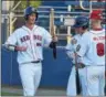  ??  ?? At left, Spring City’s Kasey Caras, left, is congratula­ted after scoring a run in the first inning against Oxford in a Chester County League playoff game Friday at Ram Stadium. At right, Spring City pitcher Chris Sparacino delivers to the plate.