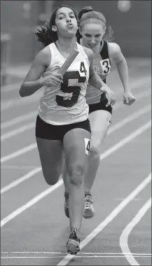  ?? DANA JENSEN/THE DAY ?? Stonington’s Vanessa Benjamin crosses the finish line just ahead of Plainfield’s Casssandra Carleson to give the Bears a victory in the 1,400-meter sprint medley relay on Saturday during the ECC Division II indoor track and field championsh­ip meet at the Coast Guard Academy. Benjamin was joined by teammates Megan Detwiler, Carly Constantin­e and Nancy Inthasit.