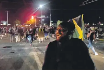  ?? David Goldman Associated Press ?? OSCAR WALTON speaks to fellow protesters during a march Wednesday against the police shooting of Jacob Blake in Kenosha, Wis. Kyle Rittenhous­e, 17, a white youth, was arrested after three people were shot Tuesday.