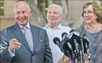  ?? Damian Dovarganes Associated Press ?? ATTORNEY Tom Girardi, left, appears with David and Ann Stow, the parents of San Francisco Giants fan Bryan Stow, who suffered brain damage from a beating, outside a Los Angeles courthouse in 2014.