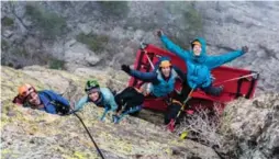  ??  ?? Harry Kent, left, Lisa Marshall, Jes Meiris and Vanessa Polcari set up the portaledge in less-than-ideal conditions.