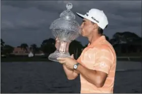  ?? MICHAEL ARES — THE PALM BEACH POST VIA AP ?? Rickie Fowler holds up the Honda Classic trophy after his win on Sunday in Palm Beach Gardens, Fla.