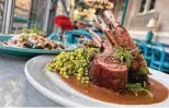  ?? ?? Lamb chops with mamey mole, foreground, and a roasted chile relleno are on the menu at Ocho at the Hotel Havana.