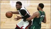  ?? CHARLES KRUPA — THE ASSOCIATED PRESS ?? Heat center Bam Adebayo, left, drives to the basket past Celtics center Tristan Thompson during the second half on Tuesday in Boston.