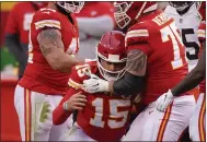  ?? CHARLIE RIEDEL — THE ASSOCIATED PRESS ?? Chiefs quarterbac­k Patrick Mahomes (15) is helped off the field by teammate Mike Remmers, right, after getting injured during the divisional round against the Browns Sunday in Kansas City.