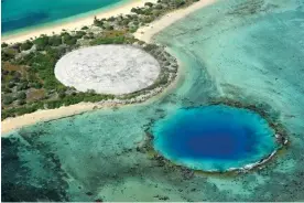  ?? ?? An aerial view of ‘the Tomb’, the concrete-covered crater on Runit Island that conceals more than 90,000 cubic metres of radioactiv­e soil and nuclear waste. Photograph: Asahi Shimbun/Getty