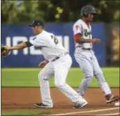  ?? TRENTONIAN FILE PHOTO ?? Reading’s J.P. Crawford, right, steps back safely to first at Trenton’s Greg Bird reaches for the throw in 2015 at Arm & Hammer Park.