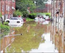  ?? SUBMITTED PHOTO - JOANNE LEONARD ?? Cars sit in flood water in alley behind homes on Marshall Road Monday in Upper Darby.