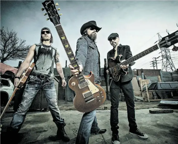  ?? MARGARET MALANDRUCC­OLO ?? The Road Hammers — from left, Clayton Bellamy, Jason McCoy and Chris Bryne — take the Koodonatio­n stage at K-Days Saturday night.