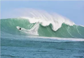  ??  ?? Davy Wooffindin rides a wave at a remote reefbreak in southern New Zealand.