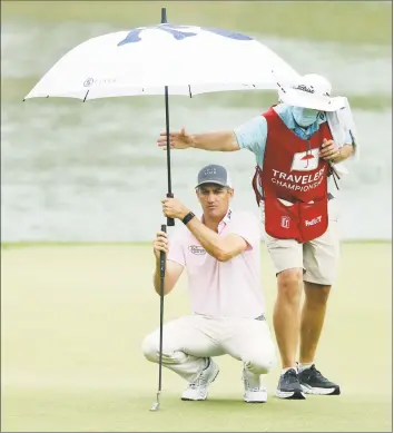  ?? Maddie Meyer / Getty Images ?? Brendon Todd of the United States lines up a putt on the 17th green during the third round of the Travelers Championsh­ip on Saturday at TPC River Highlands in Cromwell.