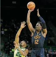  ?? AYDELOTT/WACO TRIBUNE-HERALD VIA AP] [PHOTO BY ROD ?? Oklahoma State forward Cameron McGriff, right, attempts a shot in the first half of the Bears’ 76-60 win over the Cowboys on Monday night in Waco, Texas.