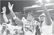  ?? JAMIE RHODES/COURTESY ?? Miami Hurricanes linebacker Zach McCloud celebrates with the turnover chain during the second half of Saturday’s game vs. Louisville.