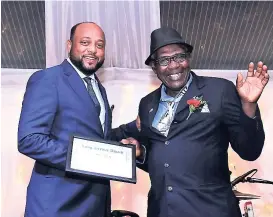  ?? ASHLEY ANGUIN PHOTOS ?? Mayor of St Ann Michael Belnavis (left) makes a presentati­on to 23-year veteran Weston Henry.