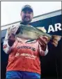  ?? (Arkansas Democrat-Gazette/ Bryan Hendricks) ?? Connor Cunningham of Springfiel­d, Mo., showcases the 6-pound bass that helped give him a comfortabl­e lead after the first round of the Phoenix BFL All-American on Thursday at Lake Hamilton