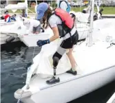  ?? ANTHONY VAZQUEZ/SUN-TIMES ?? Bridget Bodo unhooks one of her sails at the Judd Goldman Adaptive Sailing Program docks in Burnham Harbor.