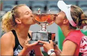  ??  ?? Czech Republic’s Katerina (L) and Krejcikova kiss The Simone Mathieu Cup after their win in the women’s double final.