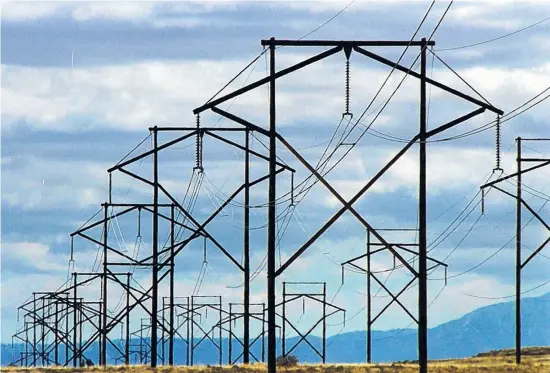  ?? JOURNAL FILE ?? PNM transmissi­on lines march across the West Mesa to deliver electrical power to Albuquerqu­e and its environs.