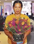  ??  ?? Liwanag Ancheta, winner of the Fossilized FlowerMaki­ng contest
