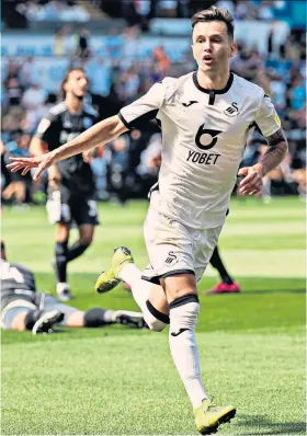  ??  ?? Clinical strike: Bersant Celina wheels away after scoring Swansea’s second goal