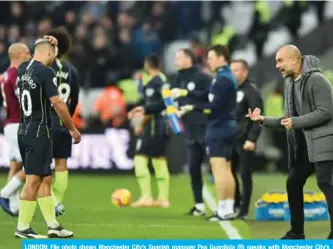  ??  ?? LONDON: File photo shows Manchester City’s Spanish manager Pep Guardiola (R) speaks with Manchester City’s Argentinia­n striker Sergio Aguero (L) from the touchline during the English Premier League football match between West Ham United and Manchester City at The London Stadium, in east London on November 24, 2018. — AFP