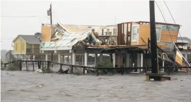  ?? Eric Gay / Associated Press ?? Homes and buildings in Rockport, Texas, feel the fury of Hurricane Harvey’s rains and flooding.