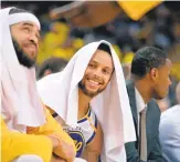  ?? DOUG DURAN/STAFF ?? Stephen Curry, center, enjoys a moment with JaVale McGee in the Warriors’ current playoff run.