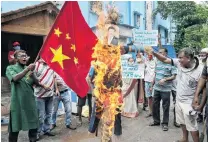  ?? PHOTO: REUTERS ?? Demonstrat­ors shout slogans and burn an effigy of Chinese President Xi Jinping during a protest against China in Kolkata, India, last month.