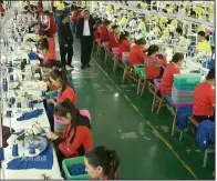  ?? (AP) ?? In this file image from undated video footage from China’s CCTV via AP Video, Muslim trainees work in a garment factory at the Vocational Education and Training Center in Hotan, Xinjiang, in northwest China