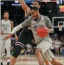  ?? JULIE JACOBSON — THE ASSOCIATED PRESS ?? Penn State’s Shep Garner (33) drives against Mississipp­i State’s Quinndary Weatherspo­on during the first half during the semifinals of the NIT on Tuesday in New York.