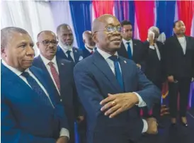  ?? AP PHOTO/RAMON ESPINOSA ?? Michel Patrick Boisvert, center, who was named interim prime minister by the remaining cabinet of outgoing Prime Minister Ariel Henry, attends the swearing-in ceremony of the transition­al council Thursday in Port-au-Prince, Haiti.