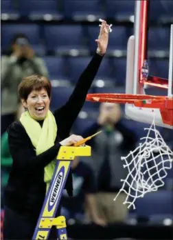  ?? RON SCHWANE — THE ASSOCIATED PRESS ?? Notre Dame head coach Muffet McGraw celebrates by cutting down the net after defeating Mississipp­i State in the final of the women’s NCAA Final Four college basketball tournament, Sunday in Columbus, Ohio. Notre Dame won 61-58.