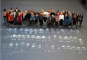  ??  ?? Volunteers stand after lying down on the heat sensitive artwork Our Neighbours.