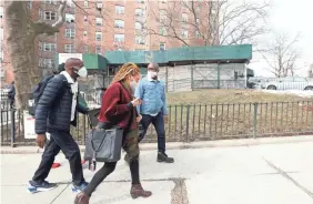  ??  ?? A group from the Bronx Rising Initiative goes door-to-door registerin­g people for vaccinatio­n Feb. 24. The organizati­on is informing people about vaccinatio­n and making it easier for those eligible to get registered and vaccinated.