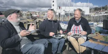  ??  ?? Kane Cunningham, John Oxley and Nick Taylor enjoying some mussels to mark the launch of Big Ideas by the Sea.