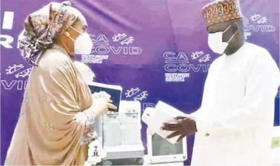  ??  ?? Umar Usman Kadafur, deputy governor, Borno State, receiving medical equipment from Fatimeh A Jarma, business developmen­t manager, Bornu, FirstBank Limited, on behalf of CACOVID-19, donated to the Borno State government in support of the fight against COVID-19 in Maiduguri, recently