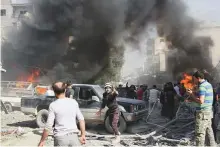  ?? AP ?? Civil Defence workers and residents gather after an air strike hit near a market in southern Idlib.