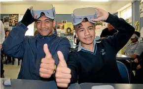  ?? ALAN APTED/STUFF ?? Mangere College students Rihari Scrivener, 13, left, and Glassie Fabian Thomas, 14, give the Parliament virtual reality app the thumbs-up.