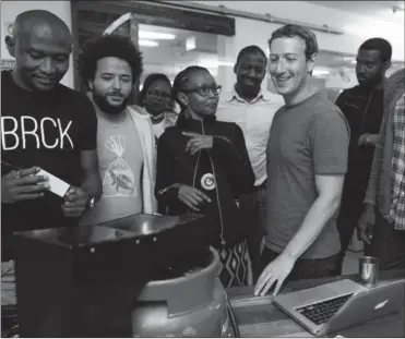  ?? PHOTO: FACEBOOK ?? Juliana Rotich shows Mark Zuckerberg how BRCK works in Kenya. Facebook launched NG_Hub with local hubs in Nigeria.